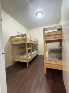 two bunk beds in a room with wooden floors at Oasis Wynwood in Miami