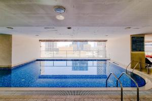 a large swimming pool in a building at ALH VAcay - Sulafa Tower - 1 Bedroom in Dubai