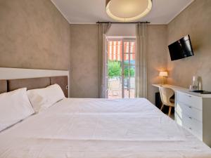 Łóżko lub łóżka w pokoju w obiekcie Hotel Conca D'Oro ***S