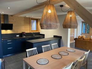 a kitchen and dining room with a table and chairs at Chalet Yuki in Morzine