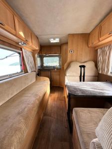 a small room with two beds in an rv at Комфортный семейный автодом на 5 человек in Tbilisi City