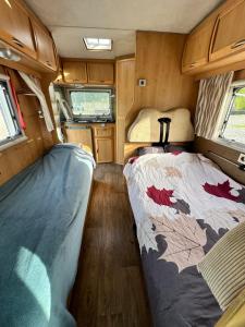 a small room with a bed in an rv at Комфортный семейный автодом на 5 человек in Tbilisi City