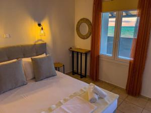 a bedroom with a bed with a view of the ocean at Studios Plaka in Skala Kallirachis