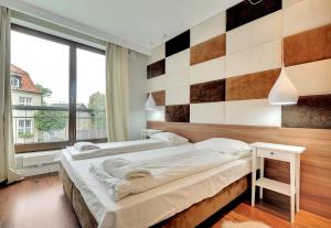 Posteľ alebo postele v izbe v ubytovaní Szafarnia Apartments Old Town
