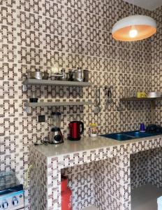 a tiled kitchen with a counter and a sink at LUXURYs apartment in Abomey-Calavi