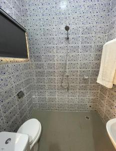 a bathroom with a shower with a toilet and a sink at LUXURYs apartment in Abomey-Calavi