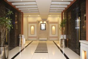 a lobby with a tile floor and a building at Fort Continental Hotel in Peshawar