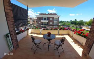 eine Terrasse mit einem Tisch und Stühlen auf dem Balkon in der Unterkunft Relax & Business Luxury Apartment Velletri in Velletri