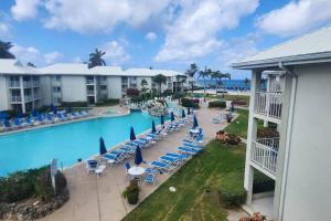 an aerial view of a pool at a resort at Sunset Cove - Condo 314 in George Town