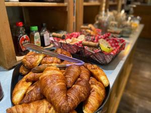 a table with a bunch of croissants and other food at Hôtel La Muette in Arles