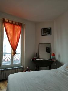 a bedroom with a bed and a sink and a mirror at Appt Letort CityCosy in Paris