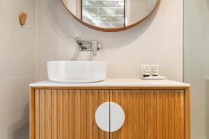 a bathroom with a sink and a mirror at Oceanic Sorrento Apartment 11 in Sorrento
