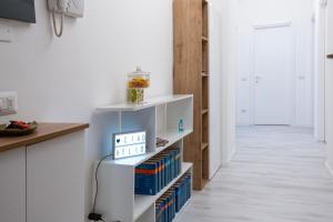a kitchen with a book shelf with books at Casa Mila in Milan