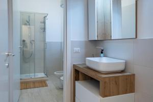 a bathroom with a white sink and a shower at Casa Mila in Milan +30 photos