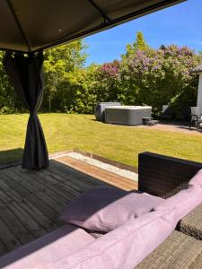 a bed on a wooden deck in a yard at Jonas Hus - Munkgaard in Store Heddinge