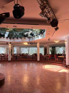 a dance floor in a restaurant with tables and chairs at Via Baltica in Sargėnai