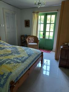 a bedroom with a bed and a chair and a window at Sanachan in Kishorn