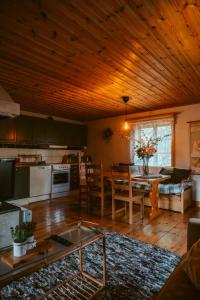 a kitchen and living room with a table and a kitchen and a dining room at The Mangevie in Furudal
