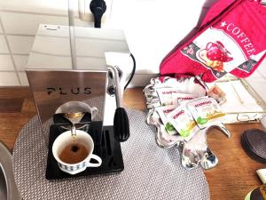 a coffee maker with a cup of coffee on a table at VANITY Apartments in Sandanski +12 photos