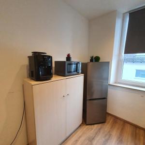 a kitchen with a microwave on top of a refrigerator at Laineckerstrasse 8 in 95445 Bayreuth in Bayreuth