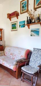 a couch and a chair in a living room at One bedroom apartement at Lacona 100 m away from the beach with enclosed garden in Lacona