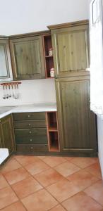 a kitchen with green cabinets and a white counter at One bedroom apartement at Lacona 100 m away from the beach with enclosed garden in Lacona