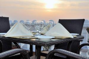 a table with wine glasses and napkins on it at Fort Continental Hotel in Peshawar