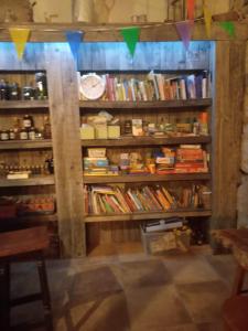 a book shelf filled with lots of books at Mountain Log Cabin O Garrano in Cabeceiras de Basto