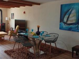 a dining room with a glass table and chairs at Katia 's Country House in Sikión