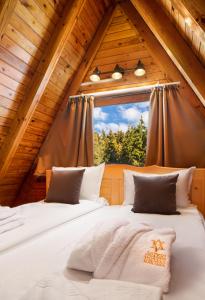 two beds in a room with a window at Chalet Musala in Borovets