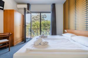 Postel nebo postele na pokoji v ubytování Hotel Al Castello