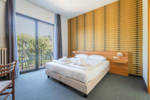 Postel nebo postele na pokoji v ubytování Hotel Al Castello