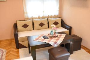 a living room with a couch and a table at Central Stay Mostar - Apartments & Rooms in Mostar