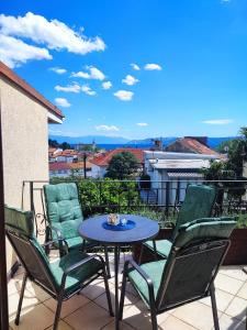 a patio with a table and chairs on a balcony at City apartment Rina in Crikvenica +1 photo