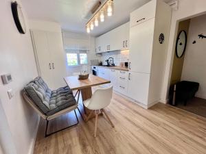 a kitchen and dining room with a table and chairs at Resita Dream Apartament in Reşiţa