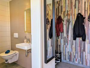 a bathroom with a sink and a toilet and a mirror at Premiumferienhaus Anni in Hasselfelde