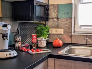 a kitchen with a counter top with vegetables and a sink at Premiumferienhaus Anni in Hasselfelde +28 photos