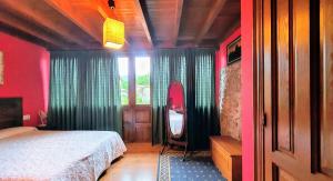 a bedroom with a bed and a mirror in a room at Llanes casa cerca de la Playa de Poo – Ekilore in Po