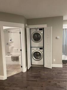 a bathroom with a washer and dryer in a room at Dominion Place Studio in Moncton +9 photos