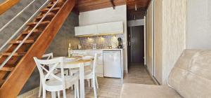 a kitchen and dining room with a table and chairs at Holiday Home SLAVIA NEW 11 in Międzyzdroje
