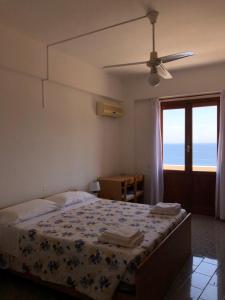 a bedroom with a bed with a view of the ocean at Hotel Ariston in Ustica