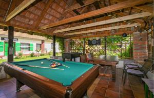 a patio with a pool table and a wooden ceiling at Beautiful Home In Hlebine With Jacuzzi in Hlebine