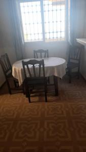 a table and chairs in a room with a window at Wardania in El Kabar