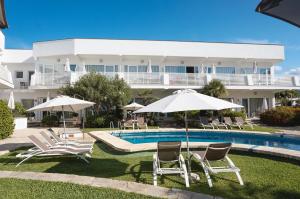 a resort with a swimming pool with chairs and umbrellas at Hoposa Montelin in Port de Pollensa