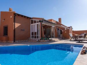 a villa with a swimming pool in front of a house at Villa in Fortuna with Private Pool in Fortuna