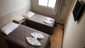 Ένα ή περισσότερα κρεβάτια σε δωμάτιο στο Hotel Ricardi Express
