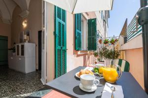 a table with a plate of food and orange juice at Old Town Bonbonniere in Bordighera