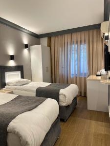 Ένα ή περισσότερα κρεβάτια σε δωμάτιο στο Hotel Peninsula