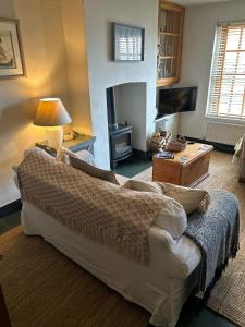 a living room with a couch and a fireplace at Harbour Cottage, Conwy in Conwy