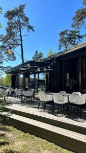 a group of chairs and tables on a patio at AC seaside apartments Albatross in Ķesterciems